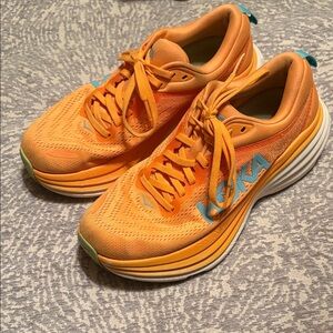 Hoka Vibrant Orange Running Shoes with Blue Highlights